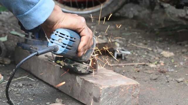Skilled artisan forges heated metal on an anvil with hammer in during axe making setting.
