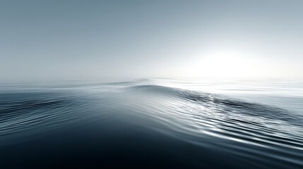 Fototapeta premium Calm and serene ocean surface with gentle waves under a bright sky