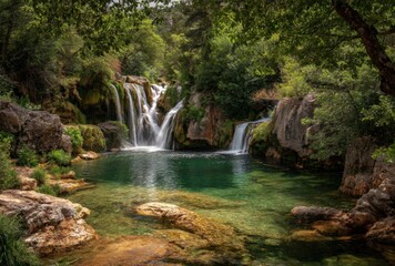 Serene natural waterfall cascading into a tranquil pool surrounded by lush greenery and rocks