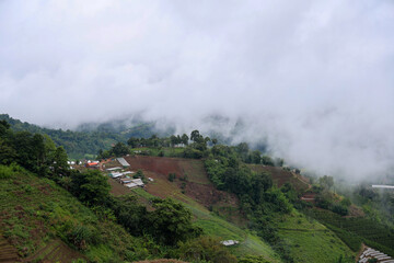 Lush Green Hills and Cloudy Sky Over Mountainous Terrain in Rural Landscape