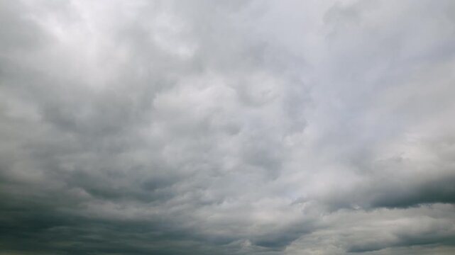 An overcast sky filled with clouds creates a moody atmosphere that captivates viewers