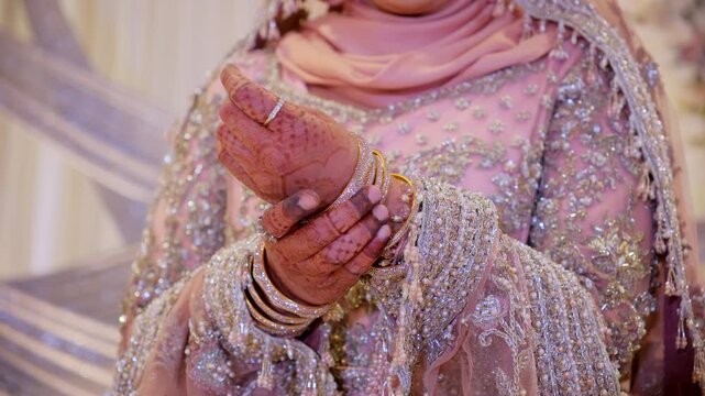Orchid color of the traditional Asian wedding clothes, Slow motion camera shote, view of variety of bangles on the hands