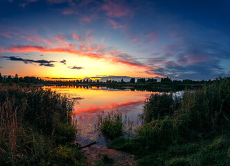 Summer sunset with beautiful sky over the lake.