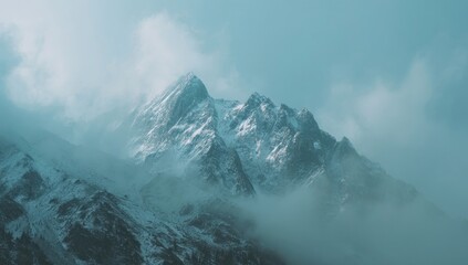 Misty mountain peak, snow-capped