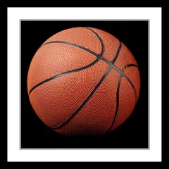 Close-up of an orange basketball on black