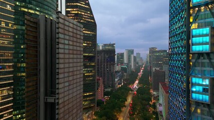 Modern skyscrapers on Reforma Avenue in Mexico City at dusk with view of Angel of Independence - Powered by Adobe