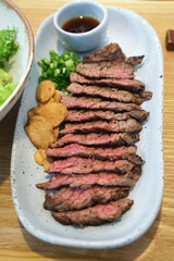 Close up sliced of tenderloin beef steak served with crispy garlic 