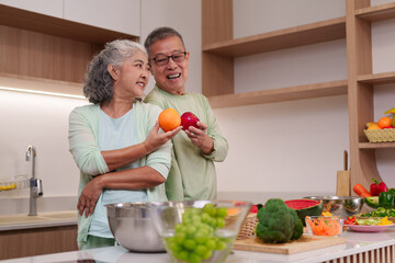 Asian senior couple prepare healthy food modern kitchen together promote wellbeing nutritious lifestyle older adults enjoy fresh produce home cooking