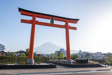 Red torii gate with Mount Fuji in background in Japan at Fujinomiya, Shizuoka, Japan,