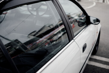 Close-Up of White Car Side Window with Reflections