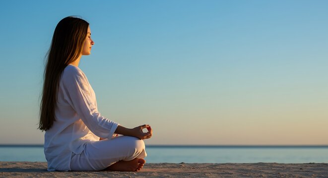 Serene woman meditates on tranquil beach at sunset, finding peace and inner calm.