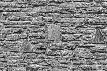 Stone wall background in black and white close up view