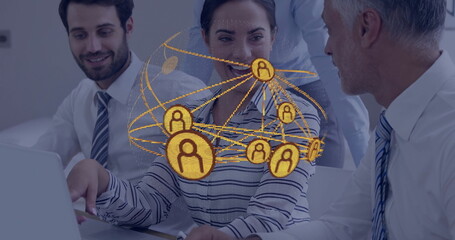 Collaborating business team discussing data on laptop in conference room, digital network overlay