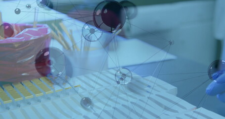Showing yellow pipette rack on lab bench with red bag, pencils, papers, glove and network overlay