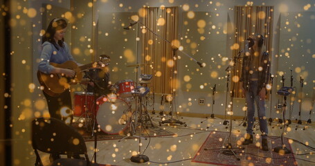 Naklejka premium Three musicians jamming together in recording studio, with acoustic guitar and drum kit