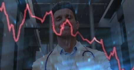 Monitoring male doctor reading red graph on display in lobby, with stethoscope, glass panels, beams