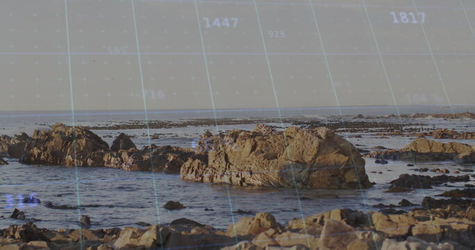 Displaying rocks rising from rocky seashore with tide pools, grid, numeric coordinates