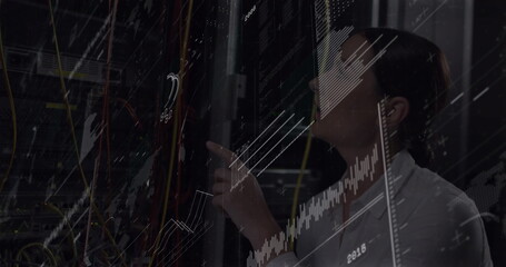 IT technician inspecting server rack in server room, with patch cables, digital graphs, copy space