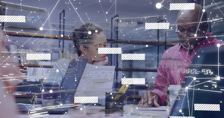 Collaborating group of four professionals analyzing data with laptops at office, with AR overlay