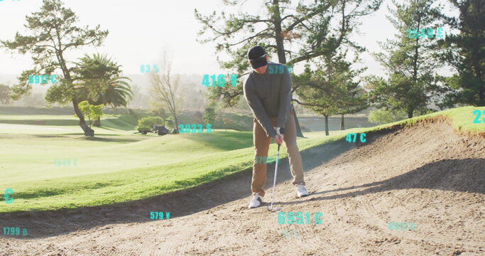 Golfer wearing golf attire swinging club at ball in sand bunker, floating data overlays, copy space