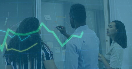 Discussing team of three wearing suits marking glass wall in office with sticky notes chart overlay