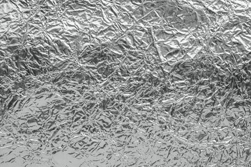 Shiny metal silver gray foil leaf crumpled texture background