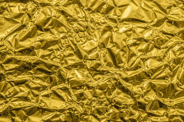 Luxury shiny metallic golden foil crumpled texture background