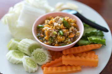 Spicy crab roe chili sauce served with many kinds of fresh vegetables. Thai called Nam Prik Kai Poo