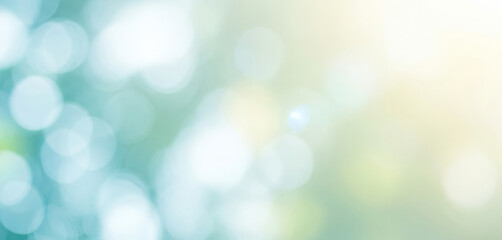 Abstract background with bokeh effect showing light blue, green, and yellow colors that form a fresh and vibrant mood, suitable for creative projects and elegant decorative visuals.