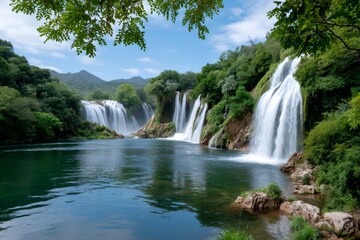 Obraz premium Kravice Waterfalls cascading into a turquoise pool in Bosnia and Herzegovina
