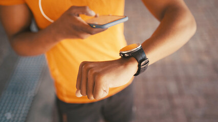 Phone, smart watch and fitness with hands of man in city for exercise app, performance sync and steps monitor. Pace tracker, athlete stats and heart rate check with above of person outdoor for cardio