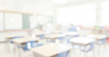 Blurred classroom interior with desks and a chalkboard in a bright setting, capturing an academic atmosphere with organized layout and welcoming educational design.