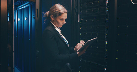 Engineer, woman and typing on tablet in server room for cybersecurity, system backup or update. Data center, serious person or digital app for network configuration, technical solution or maintenance