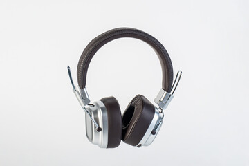 Fototapeta premium Two-tone silver and brown wireless headphones, Headphones isolate on white background. Wireless headphones in brown.