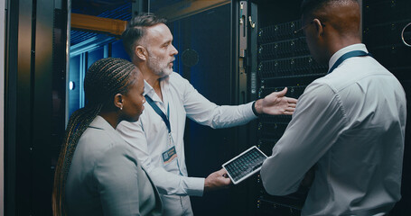 People, cyber security and tablet in server room, conversation and teamwork with engineering. IT specialist, technical support or employees with discussion, problem solving or data center with update