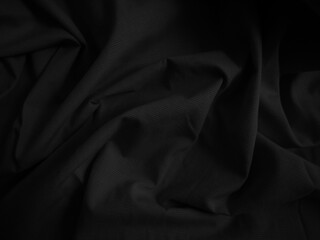 Black crumpled fabric texture. Dark cloth background