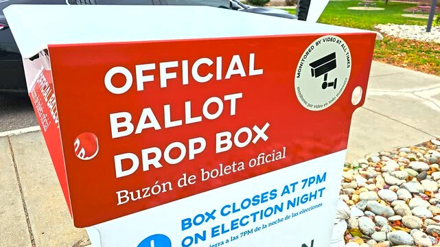 A sturdy outdoor mail-in ballot drop box marked “Official Ballot Drop Box” and “Buzón de Boleta Oficial,” providing voters a safe, official, and convenient way to submit election ballots by mail.