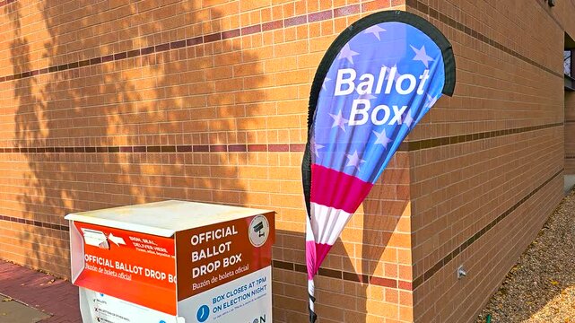 A large metal drop box, labeled &ldquo;Official Ballot Drop Box&rdquo; in English and &ldquo;Buz&oacute;n de Boleta Oficial&rdquo; in Spanish, provides voters with a safe official location to submit completed mail-in voting ballots