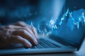 Close-up of hands typing on laptop with stock chart overlay