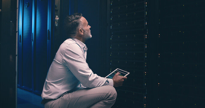 Tablet, inspection and technician or man in server room for cyber security, software update or database system. Programmer, maintenance and cybersecurity with mature person in data center as engineer