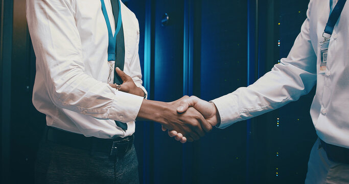 Agreement, meeting and people shaking hands in server room for network administration deal. Cybersecurity, handshake and thank you with team in data center for tech support collaboration or welcome - Powered by Adobe