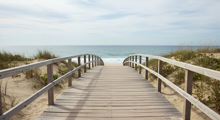 Fototapeta premium A Wooden boardwalk extending peacefully over calm tranquil blue ocean waters