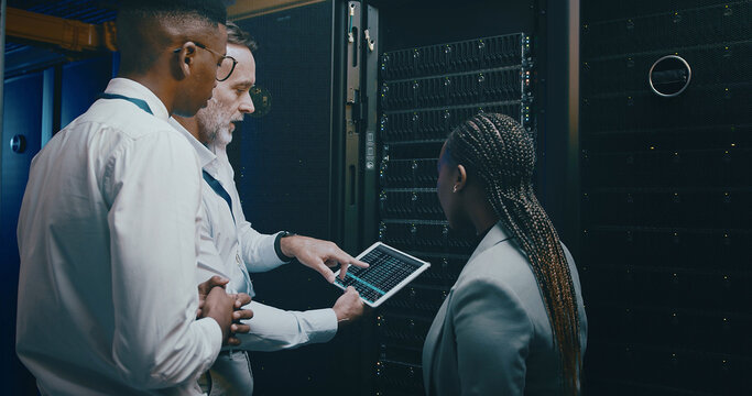 Server room, training and man with people on tablet for cybersecurity, diagnostics test and maintenance. IT team, meeting and worker with manager for network, online database and technical support - Powered by Adobe