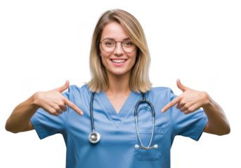Young female doctor or nurse in blue scrubs wearing glasses and stethoscope, smiling and pointing down, isolated on transparent background