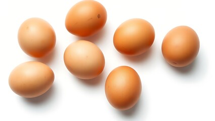 Brown eggs on a white surface, showcasing natural texture and subtle shadows in a minimalist composition.