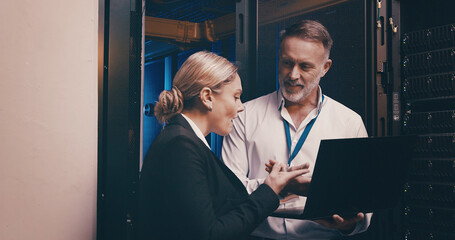 Laptop, discussion and people with in server room for technical support, database or cybersecurity. Computer, teamwork and technicians with system upgrade in data center for network programming.