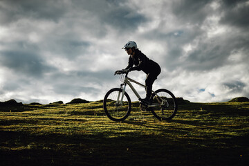 Fototapeta premium Riding mountain bike on grassland mountains