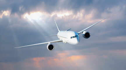 White passenger airplane flying in the sky amazing clouds in the background - Travel by air transport
