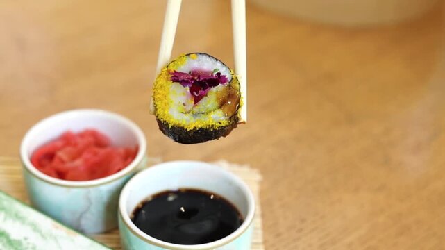 Sushi on platter with chopsticks wasabi and soy sauce on side