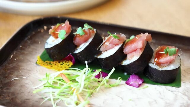 Sushi on platter with chopsticks wasabi and soy sauce on side